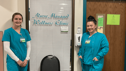 Students stand in front of the Nurse Managed Wellness Clinic